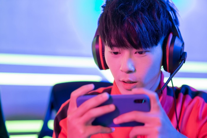 Person playing games on smartphone.